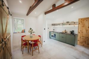 a kitchen with a table and chairs and a counter at Śliwkowy Sad-Plum Orchard-Jura in Mirów
