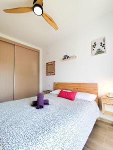 a bedroom with a bed with a ceiling fan at l'Alqueria de Laguar - Casa rural al Barranc de l'Infern in Benimaurell