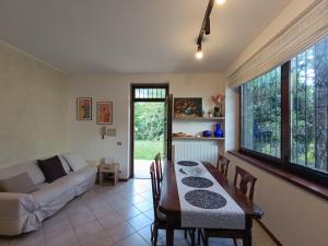 a living room with a table and a couch at Portico sul lago in Oliveto Lario