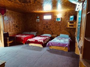 a room with two beds and a tv in it at Taimoor Hotel swat Kalam in Kalām