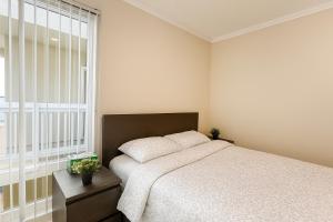 a bedroom with a bed and a large window at Ocean Haven Beachfront Getaway by Redondo Pier in Redondo Beach