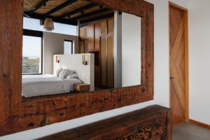 a mirror in a room with a bed and a window at Aviva, brand new designer luxury villa in Vichayito