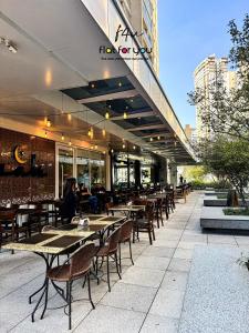 a restaurant with tables and chairs on a patio at #1806A# - Apto 1 quarto- Metropolitan Barcelona in Goiânia