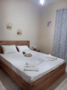 a bed with white sheets and towels on it at See view apartment in Dhimínion