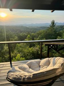 a white couch sitting on a deck with a view at Top of the Mountain Breathtaking Views Hot Tub in Blue Ridge