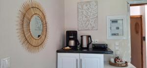a kitchen with a counter and a mirror on the wall at MANI HOLIDAYS Rooms in Neo Itilo +6 photos