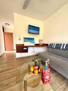 a living room with a table with a bowl of fruit at La Gaëline - Wifi, Accès Plage 2 Min à Pieds in Grand-Bourg