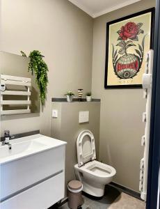 a bathroom with a white toilet and a sink at Chambre style hôtel in Sablet +19 photos