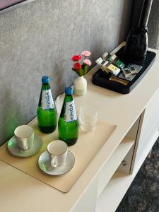 two bottles of soda sitting on a counter with cups at Hey Charlie in Jantar +23 photos