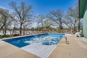 a swimming pool with snow on the ground at Love Lake Retreat with Hot Tub in New Richmond! in New Richmond