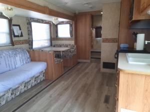a view of the kitchen and bathroom of a rv at RV 2 min to Las Vegas Strip in Las Vegas