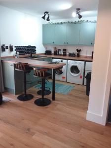 a kitchen with a table and a washing machine at Kingfisher Luxury Tent, Howdales in Louth