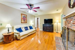 a living room with a couch and a flat screen tv at 3 Mi to Historic Dtwn Family Retreat in Beaufort! in Beaufort