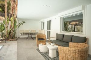 a living room with a couch and chairs and a table at El Mar, Pool House with 3 BDR, 7 min from beach in Saronida