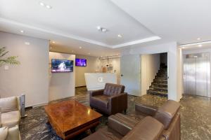 a living room with a couch and a table at Cardim Plaza Hotel in São Paulo
