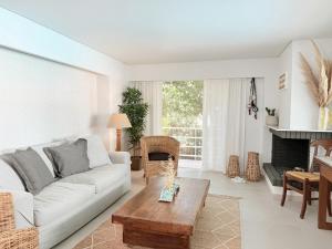a living room with a white couch and a table at El Mar, Pool House with 3 BDR, 7 min from beach in Saronida