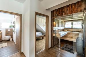 a bathroom with a glass shower and a bedroom at Ferienbahnhof Fichtental Bahnhofs-Loft in Prackenbach