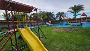 a playground with a yellow slide at Hotel y Cabañas Manolo in El Pedregal
