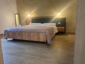 a bedroom with a large bed with two pillows at B&B Airport 26 in Azzano San Paolo