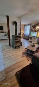 a living room with a wood stove and a couch at The Cottages - Pet Friendly in Meißendorf