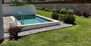 a swimming pool in the middle of a yard at Acacia - Explore your senses in Preveza
