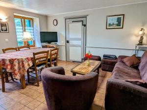 a living room with a couch and a table and chairs at Grande maison au cœur des Vosges, escapades et nature - FR-1-583-466 in Belfahy