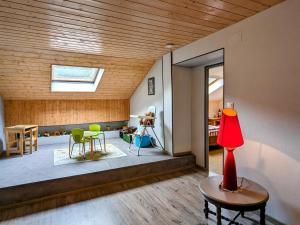 a living room with a red lamp on a table at Grande maison au cœur des Vosges, escapades et nature - FR-1-583-466 in Belfahy