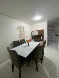 a dining room with a white table and chairs at Casa na Suíça baina in Vitória da Conquista