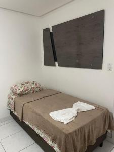 a bedroom with a bed and a large window at Casa na Suíça baina in Vitória da Conquista