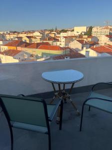 a table and two chairs on a balcony with a view at BE ONE HOTEL Caldas da Rainha - by MHMB Hospitality in Caldas da Rainha