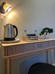 a table with a tea kettle and other items on it at BE ONE HOTEL Caldas da Rainha - by MHMB Hospitality in Caldas da Rainha
