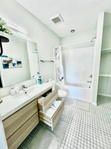 a bathroom with a sink and a shower and a toilet at Skyline Solace in Des Moines +33 photos