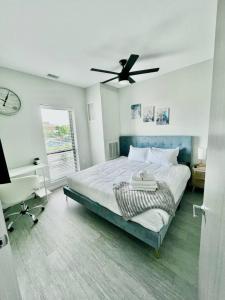 a bedroom with a bed with a ceiling fan at Skyline Solace in Des Moines +33 photos