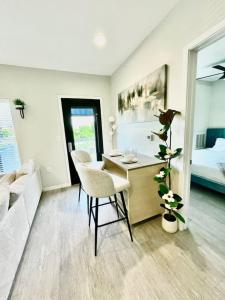 a living room with a desk and a bedroom at Skyline Solace in Des Moines