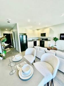 a kitchen and living room with a table and chairs at Skyline Solace in Des Moines