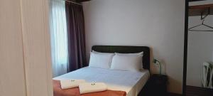 a bedroom with a bed with two towels on it at Dimora Muneghette 181 by ApartSuite in Chioggia