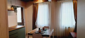 a dining room with a table and a window at Dimora Muneghette 181 by ApartSuite in Chioggia