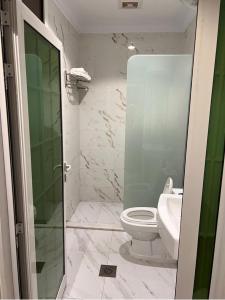 a bathroom with a white toilet and a sink at شقق الحنوة للوحدات السكنية in Sakakah +2 photos