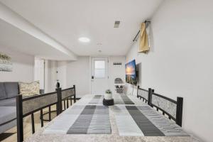 a living room with a table and a couch at Comfy 2BR Apt near Beach and Downtown Free Parking in Oshawa