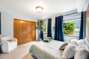 a bedroom with a large bed and a window at Magical Mountain Retreat in Juneau
