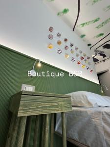 a bedroom with a bed and a sign that reads boutique box at B&B Margherita Lido Marini in Lido Marini +1 photo