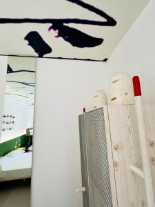 a room with a bed and a black bird on the ceiling at B&B Margherita Lido Marini in Lido Marini