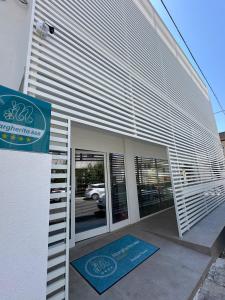 a building with a sign on the side of it at B&B Margherita Lido Marini in Lido Marini