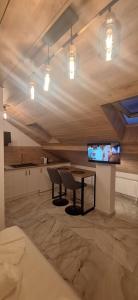 a room with a table and a flat screen tv at *Studio David* in Sibiu