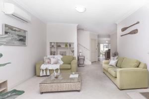 a living room with two couches and a coffee table at Beachside Warrnambool CBD in Warrnambool