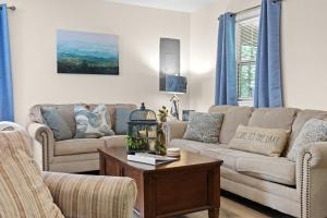 a living room with two couches and a table at Rough River Lake Hideaway Your Lakeside Escape in Fentress McMahan