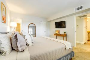 a white bedroom with a large bed with pillows at Walkable Old Town Scottsdale Condo Pool and Hot Tub in Scottsdale +16 photos