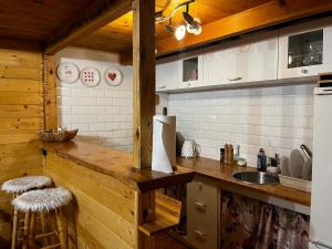 a kitchen with a wooden counter and a sink at U Dziadka in Witryłów