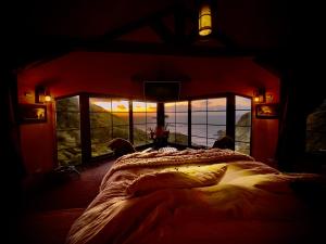 a bedroom with a bed with a view of the ocean at Loft in Patagonia Chiloe Island, Duhatao - Pumillahue in Ancud