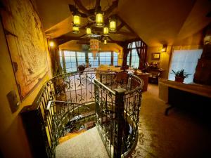 a dining room with a spiral staircase in a building at Loft in Patagonia Chiloe Island, Duhatao - Pumillahue in Ancud